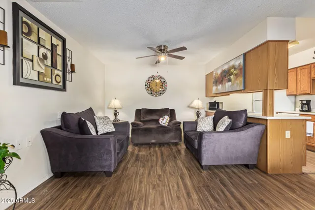 a living room with furniture and a wooden floor