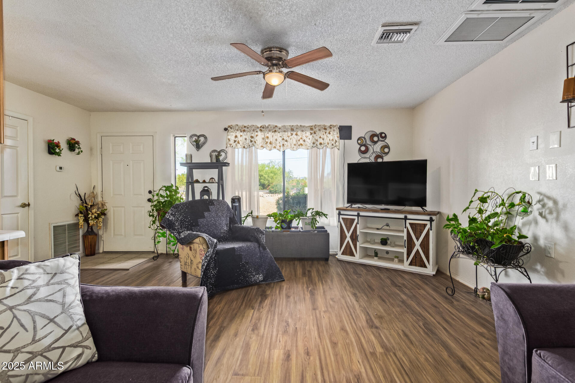 1440 North Idaho Road, Unit 1081 Apache Junction, AZ 85119 - Photo 10 of 33 a living room with furniture a flat screen tv and a large window