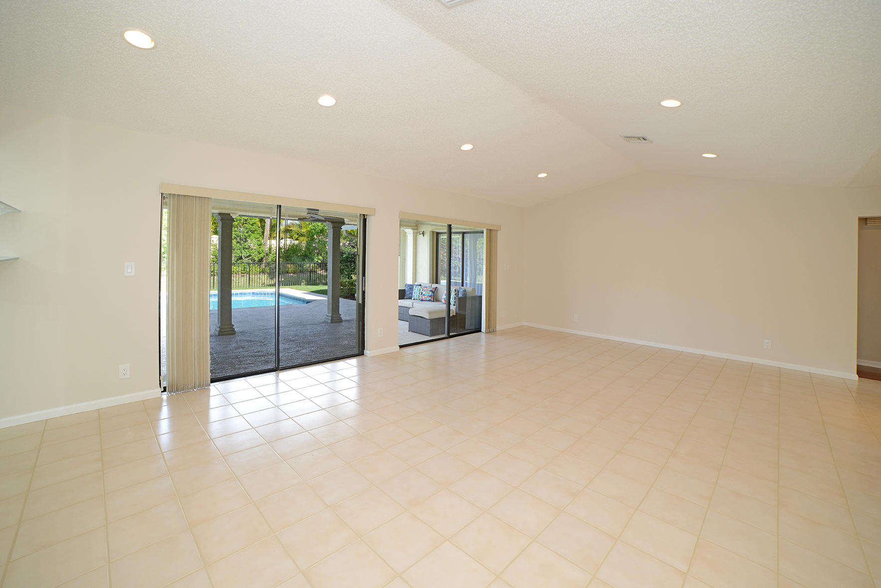 9053 Old Pine Road Boca Raton, FL 33428 - Photo 13 of 42 an empty room with floor to ceiling window and glass door