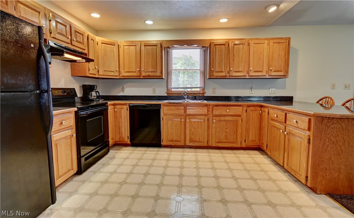 3318 Simpson Road Southeast Dennison, OH 44621 - Photo 11 of 31 Kitchen with sink, black appliances, and light tile patterned floors