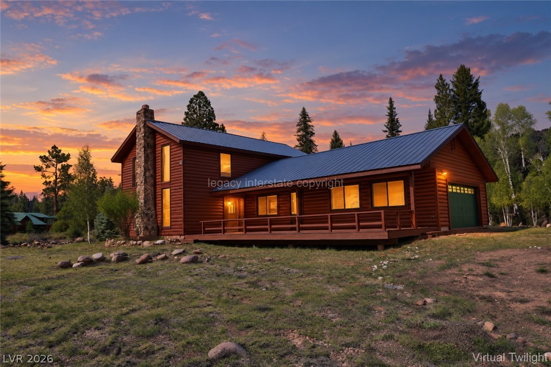 1129 East Ponderosa Road Hatch, UT 84735 - Photo 1 of 47 Log siding, a stone chimney, and a metal roof define this rustic mountain retreat.