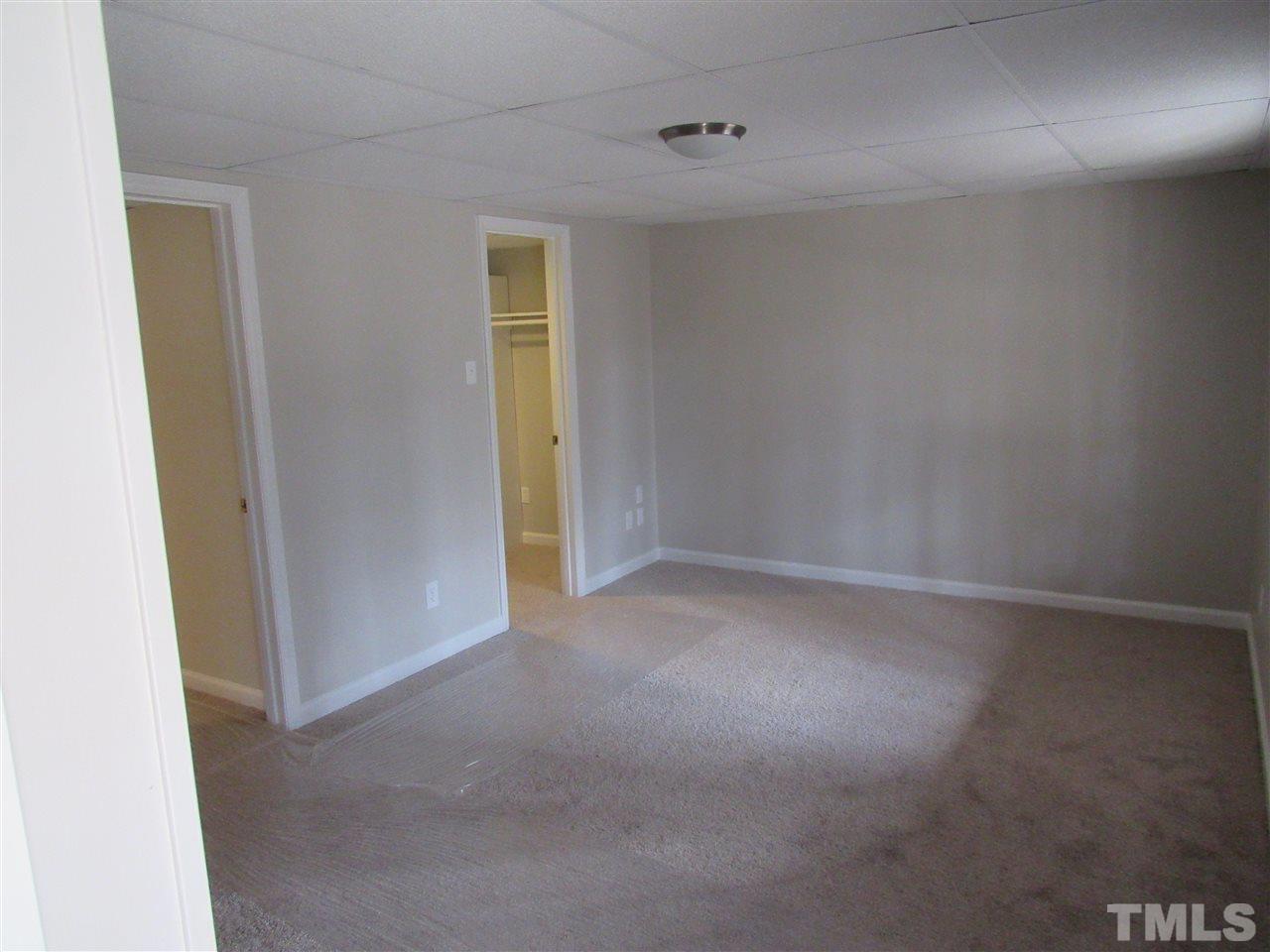 7405 Post Oak Road Raleigh, NC 27615 - Photo 9 of 24 This giant basement bedroom has a huge walk in closet. Brand new carpet throughout the entire house!