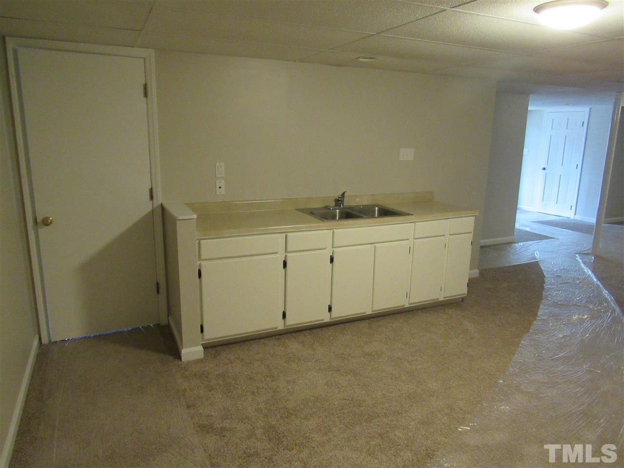 7405 Post Oak Road Raleigh, NC 27615 - Photo 10 of 24 WET BAR in the Basement, with disposal. Could be made into a basement kitchenette.