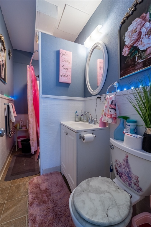 78 Gage Street Worcester, MA 01604 - Photo 13 of 25 a bathroom with a toilet a sink and a mirror
