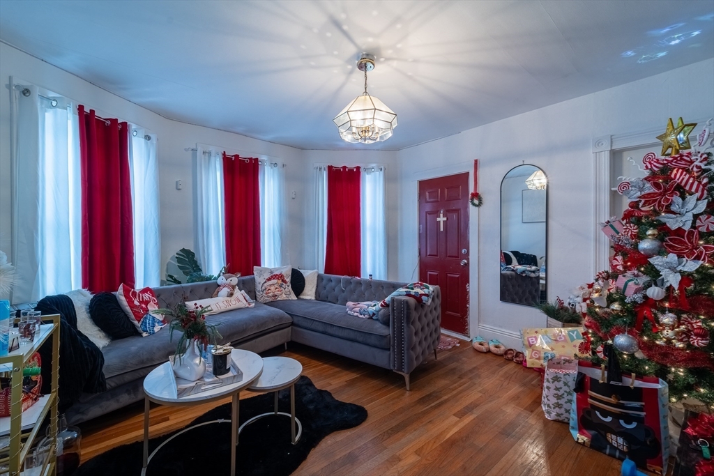 78 Gage Street Worcester, MA 01604 - Photo 4 of 25 a living room with furniture a chandelier and a window