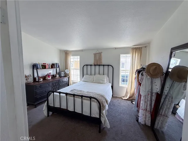 a bedroom with furniture and a mirror