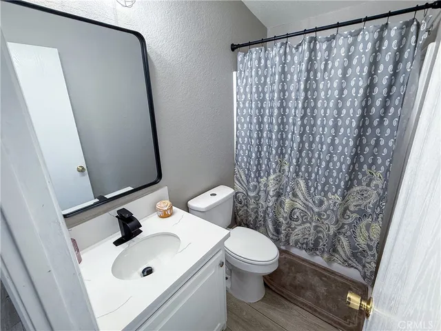a white toilet sitting next to a white sink