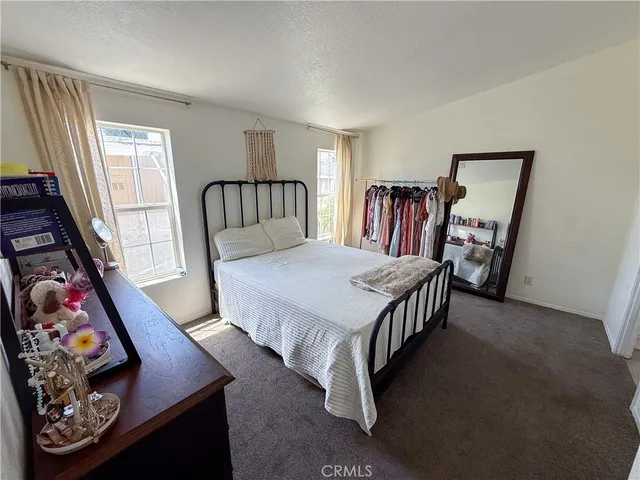 a bedroom with a bed furniture and a large window