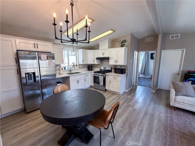a view of a dining room with furniture kitchen and wooden floor