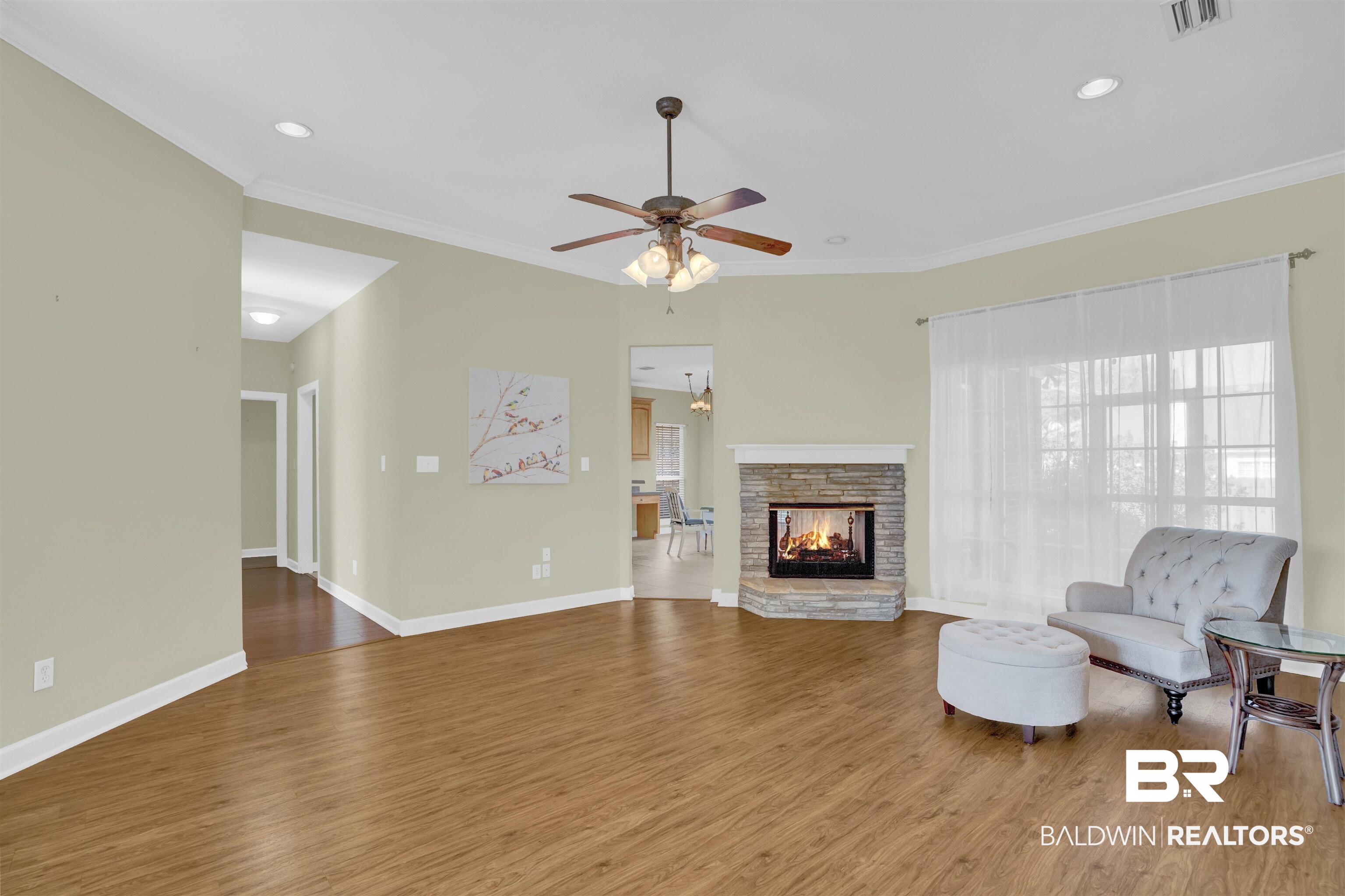 100 Conti Court Fairhope, AL 36532 - Photo 20 of 54 Living room featuring hardwood / wood-style flooring, ceiling fan, and ornamental molding
