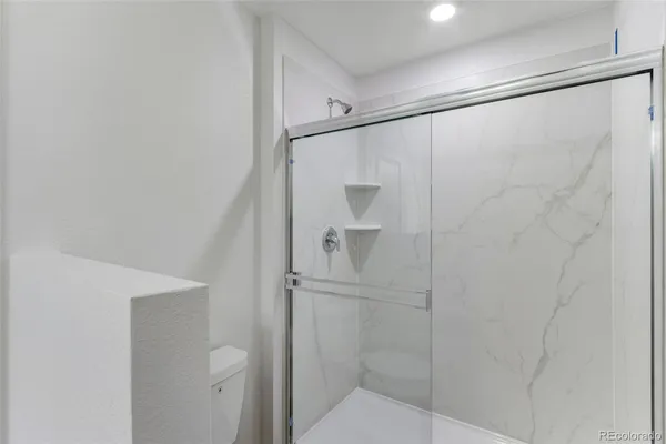 a bathroom with a glass shower door