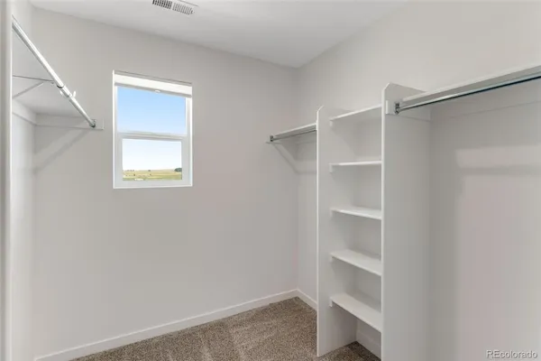 a view of an empty walk in closet
