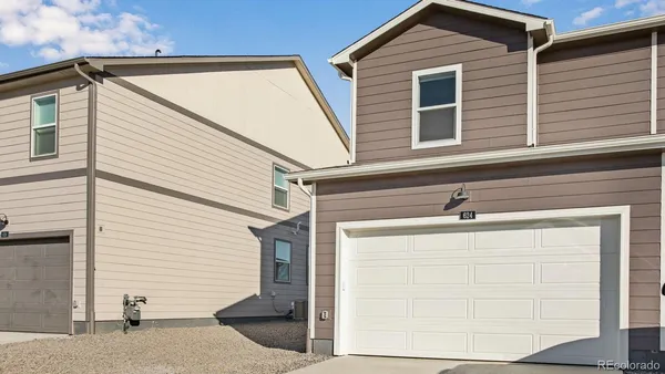 a view of a house with white door and a garage