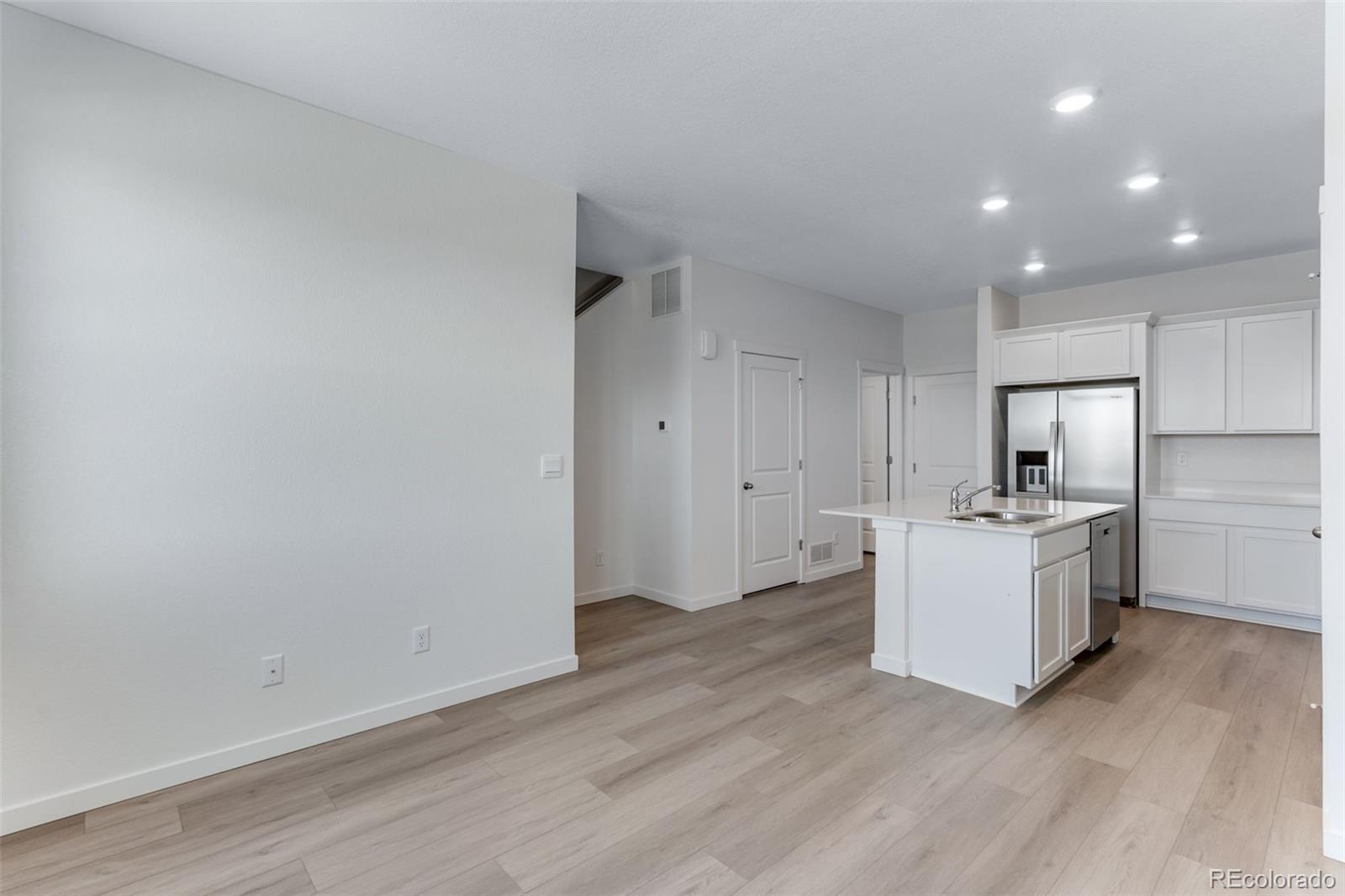 2356 Merlot Street Fort Lupton, CO 80621 - Photo 5 of 24 a room with stove and white cabinets