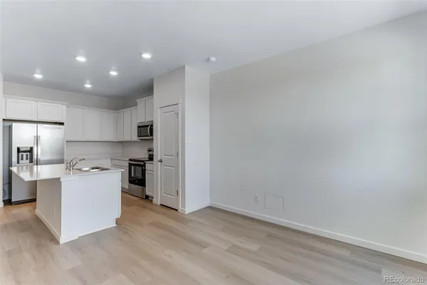 a kitchen with a sink and refrigerator