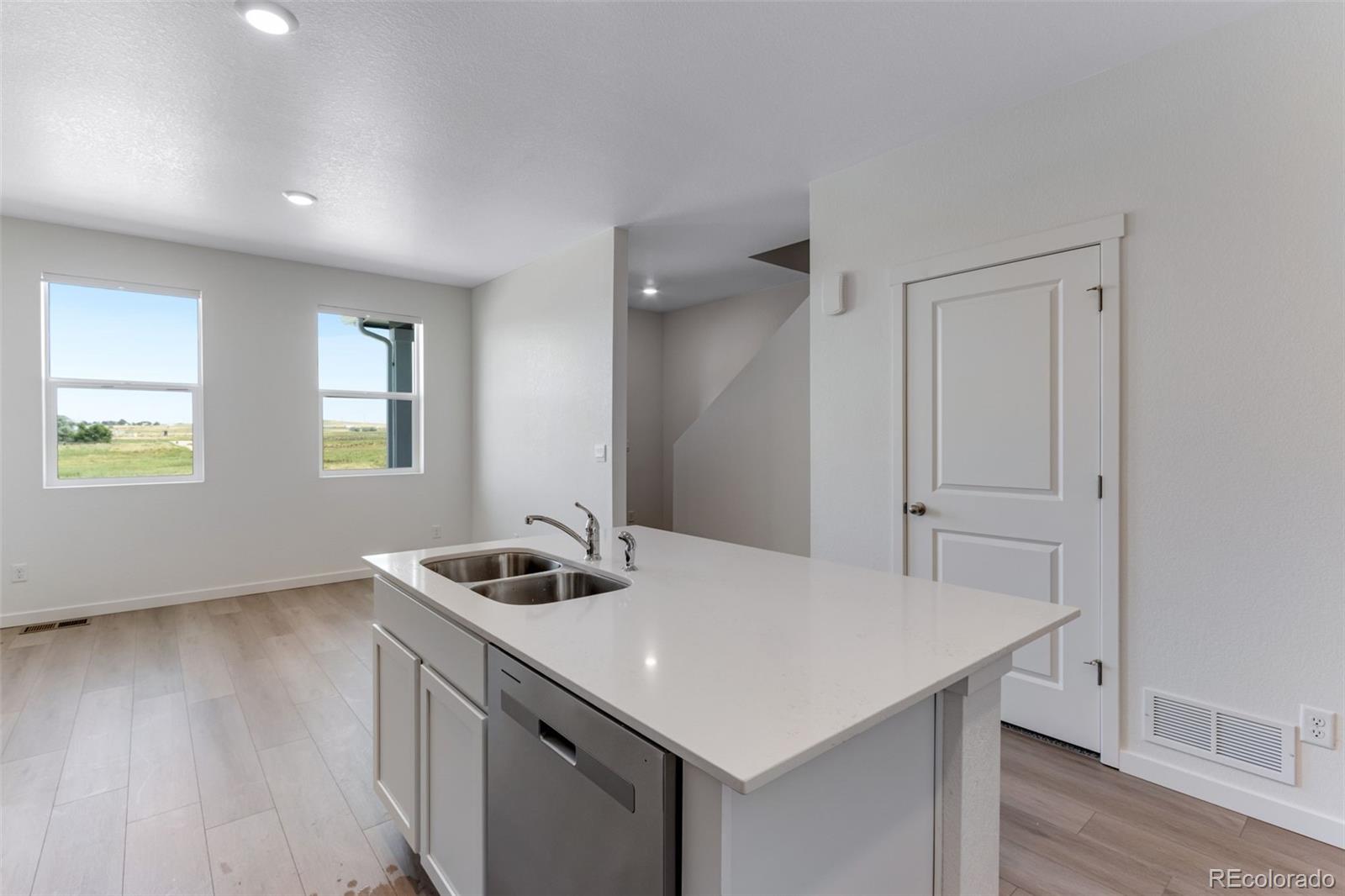 2356 Merlot Street Fort Lupton, CO 80621 - Photo 10 of 24 a kitchen that has a sink a table and chairs in it