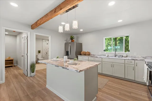 a kitchen with a sink cabinets and wooden floor