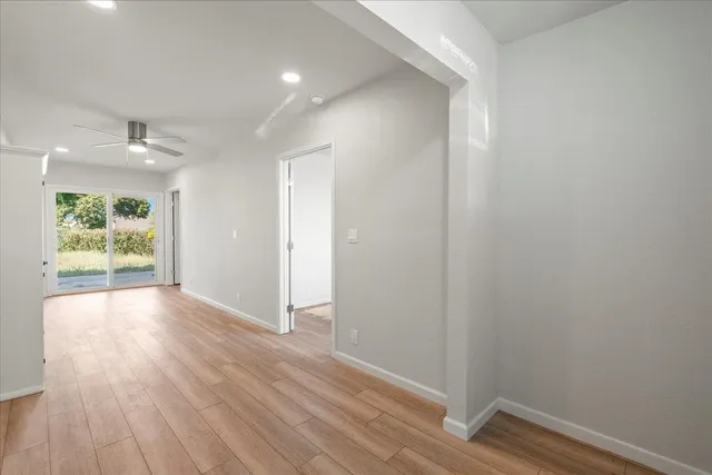 a view of hallway with wooden floor