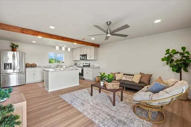 a kitchen with a refrigerator and white cabinets