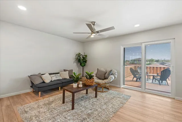 a living room with furniture and a floor to ceiling window