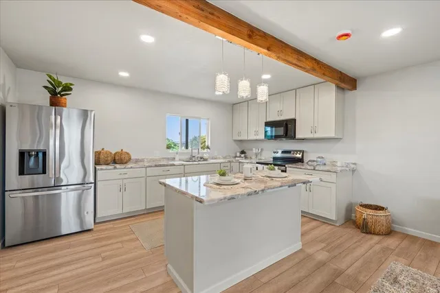 a kitchen with a sink stainless steel appliances and cabinets