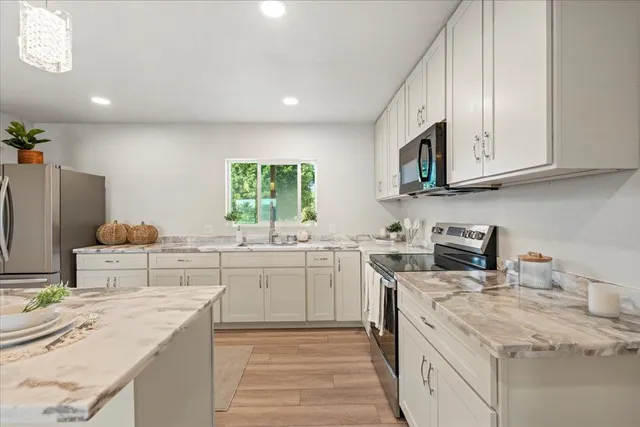 a kitchen with a sink stove and cabinets