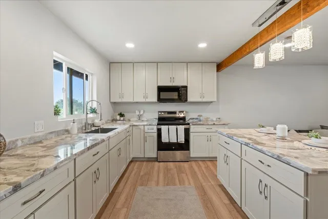 a kitchen with a sink stove and cabinets