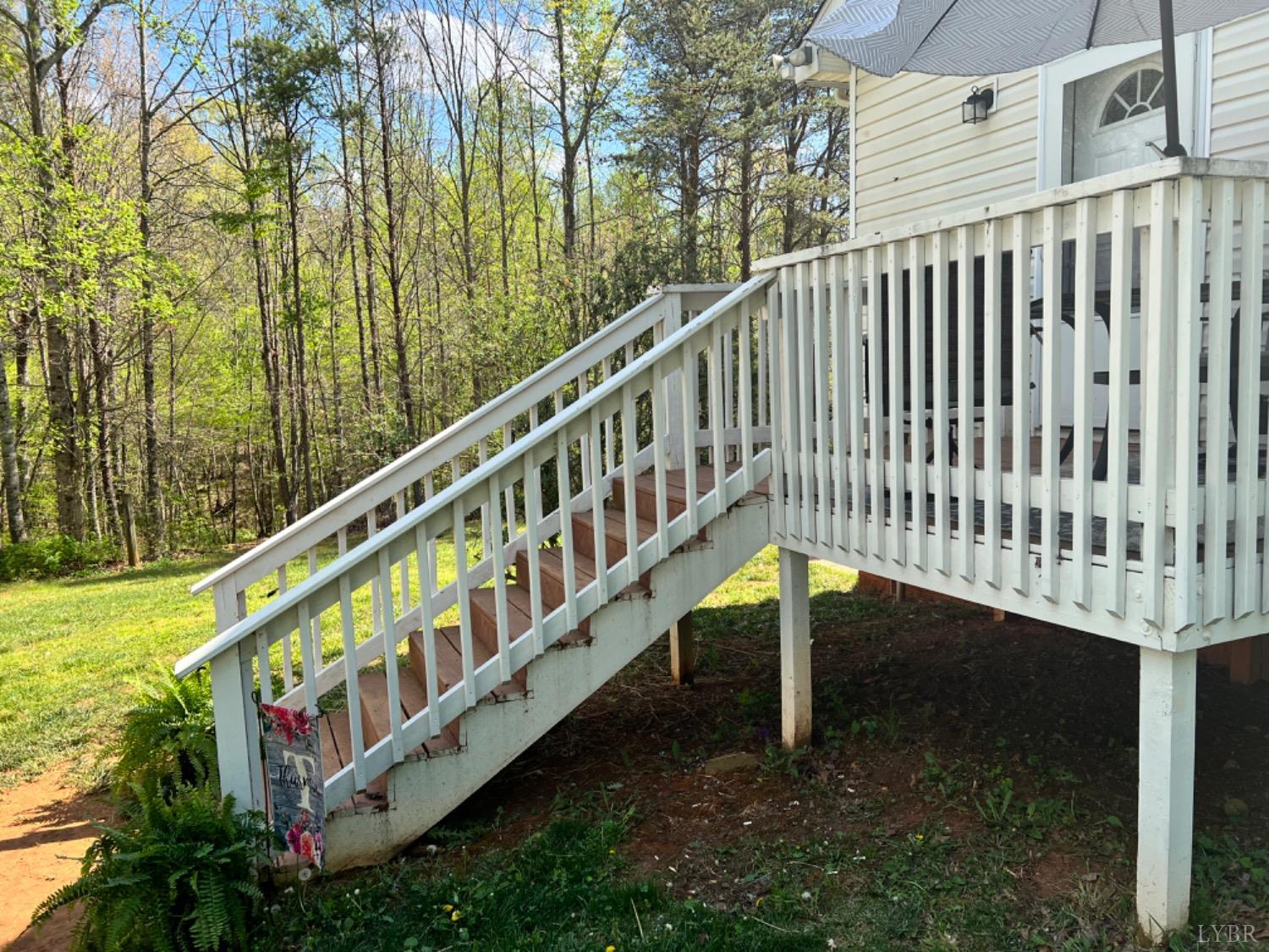 5396 Roark Mill Road Hurt, VA 24563 - Photo 19 of 25 a view of a balcony with wooden floor and fence