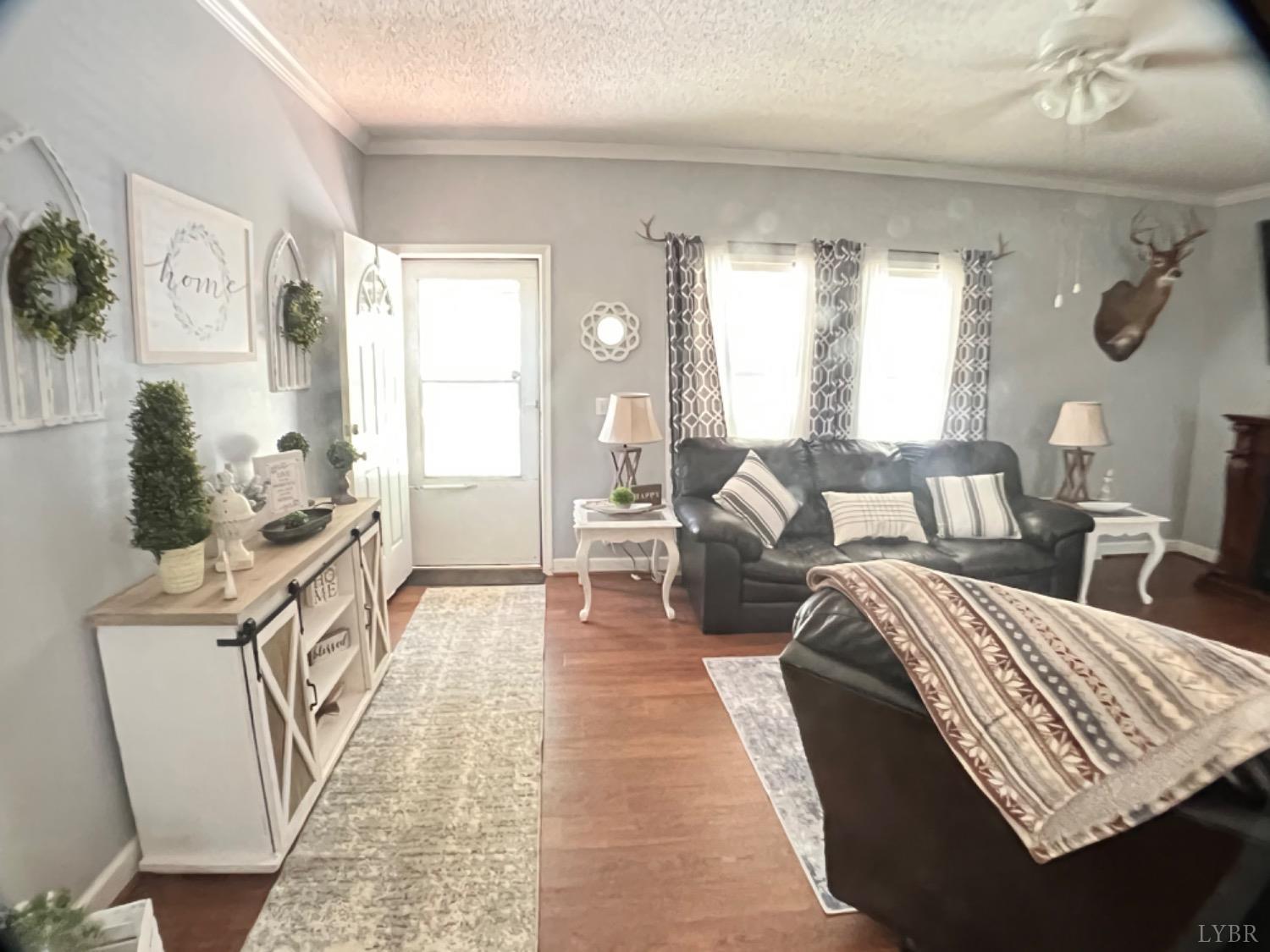 5396 Roark Mill Road Hurt, VA 24563 - Photo 6 of 25 a living room with furniture and a wooden floor