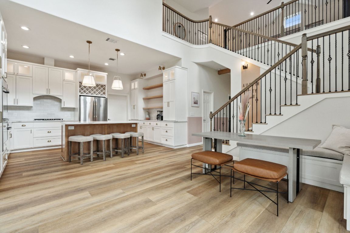 800 Newcastle Drive Austin, TX 78745 - Photo 1 of 1 a living room with furniture and a dining table with wooden floor