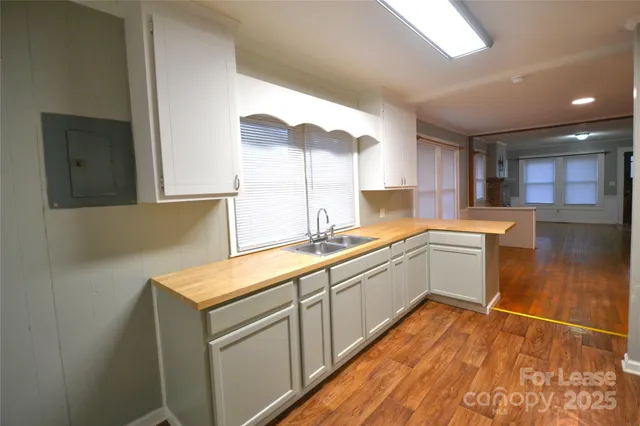 a kitchen with a sink window and cabinets