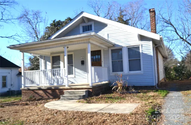 a view of a house with a yard and sitting area
