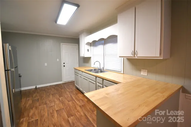 a kitchen with stainless steel appliances granite countertop a sink and a stove