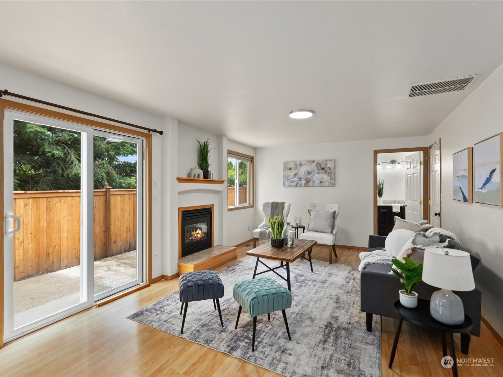3415 189th Street Southeast Bothell, WA 98012 - Photo 12 of 33 a living room with furniture a fireplace and a floor to ceiling window
