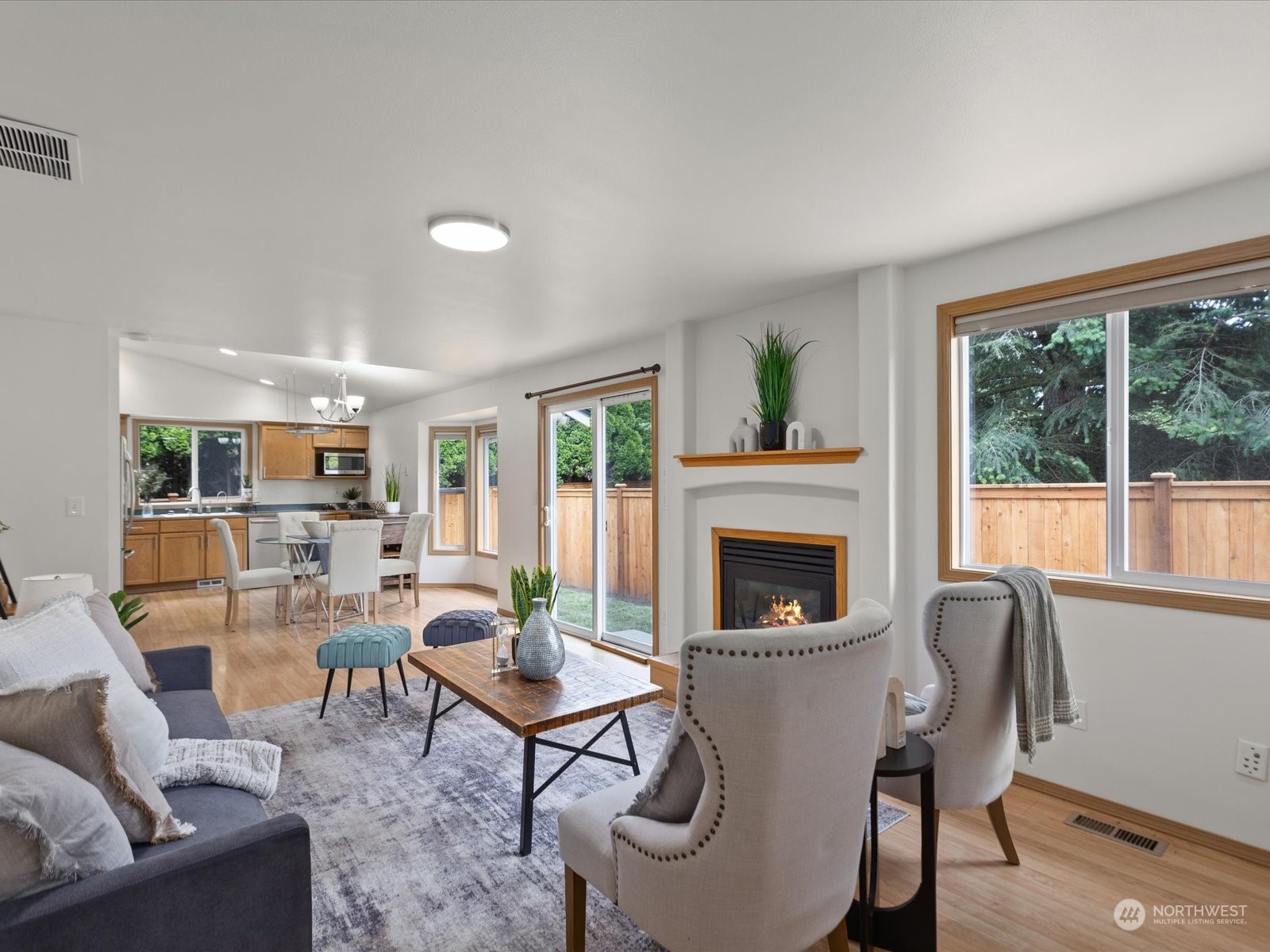 3415 189th Street Southeast Bothell, WA 98012 - Photo 14 of 33 a living room with furniture a fireplace and a floor to ceiling window