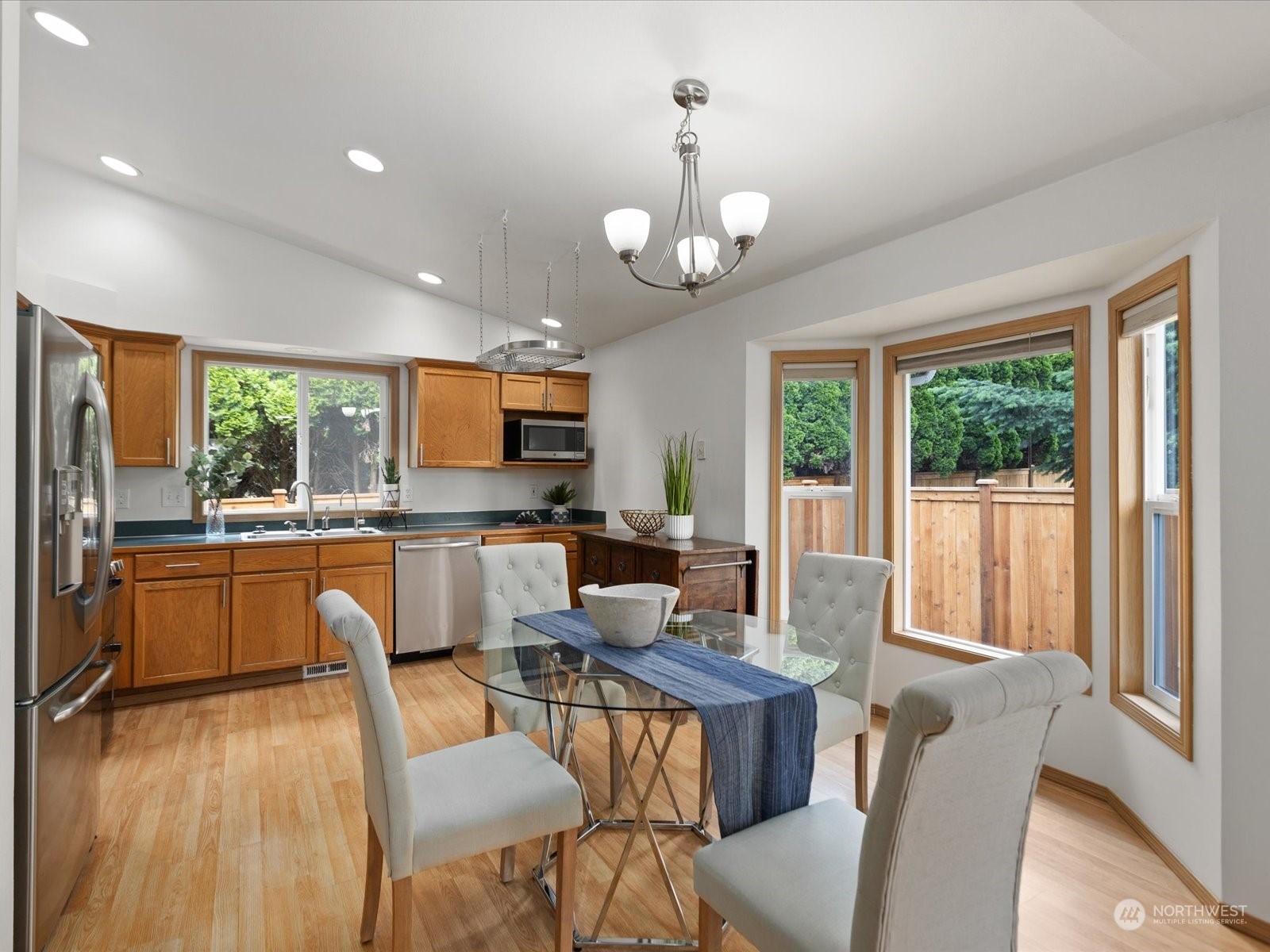 3415 189th Street Southeast Bothell, WA 98012 - Photo 16 of 33 a view of a dining room with furniture a chandelier and wooden floor