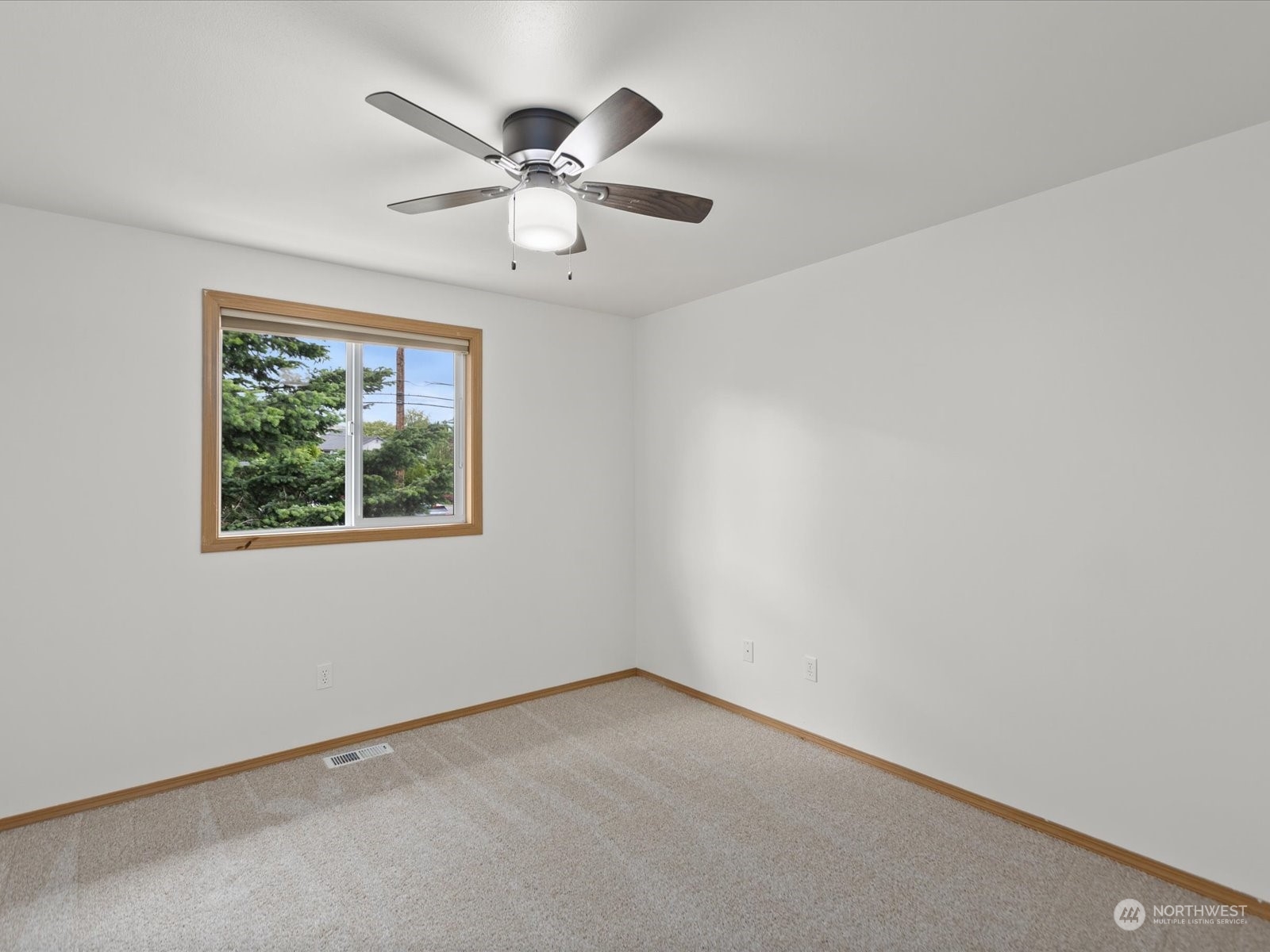 3415 189th Street Southeast Bothell, WA 98012 - Photo 23 of 33 an empty room with a window and a fan