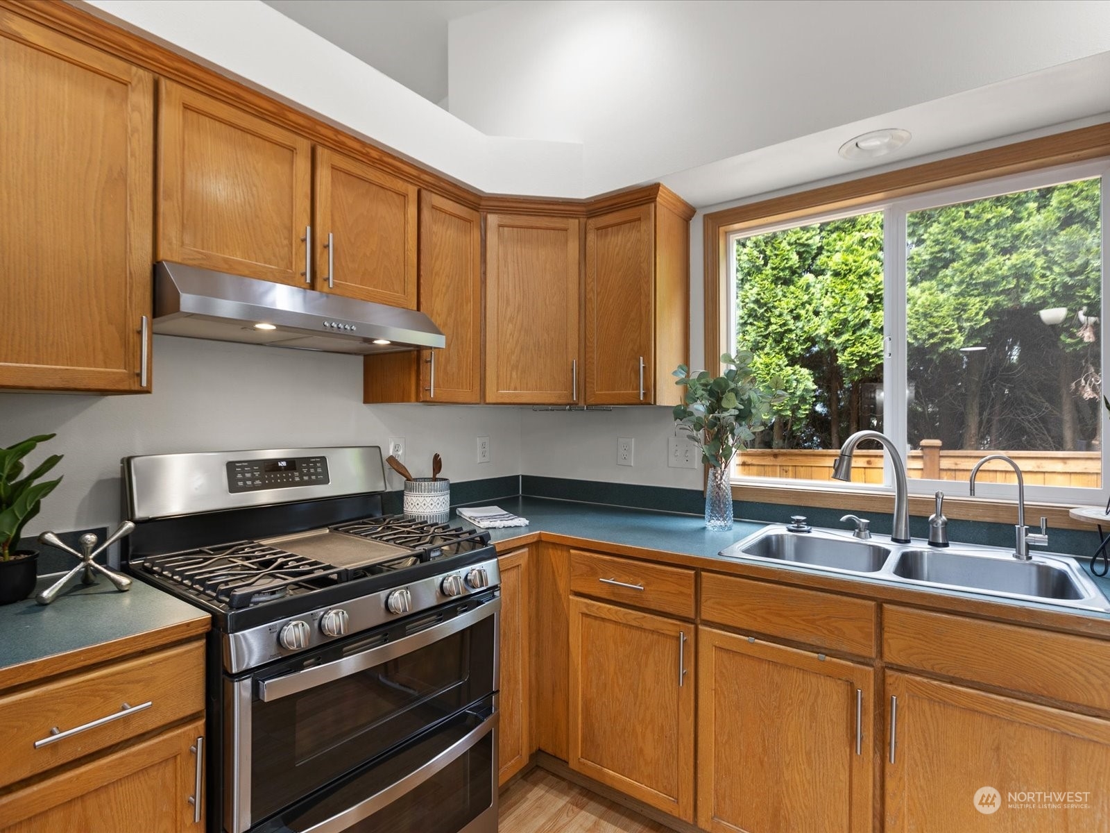 3415 189th Street Southeast Bothell, WA 98012 - Photo 9 of 33 a kitchen with sink a stove and cabinets
