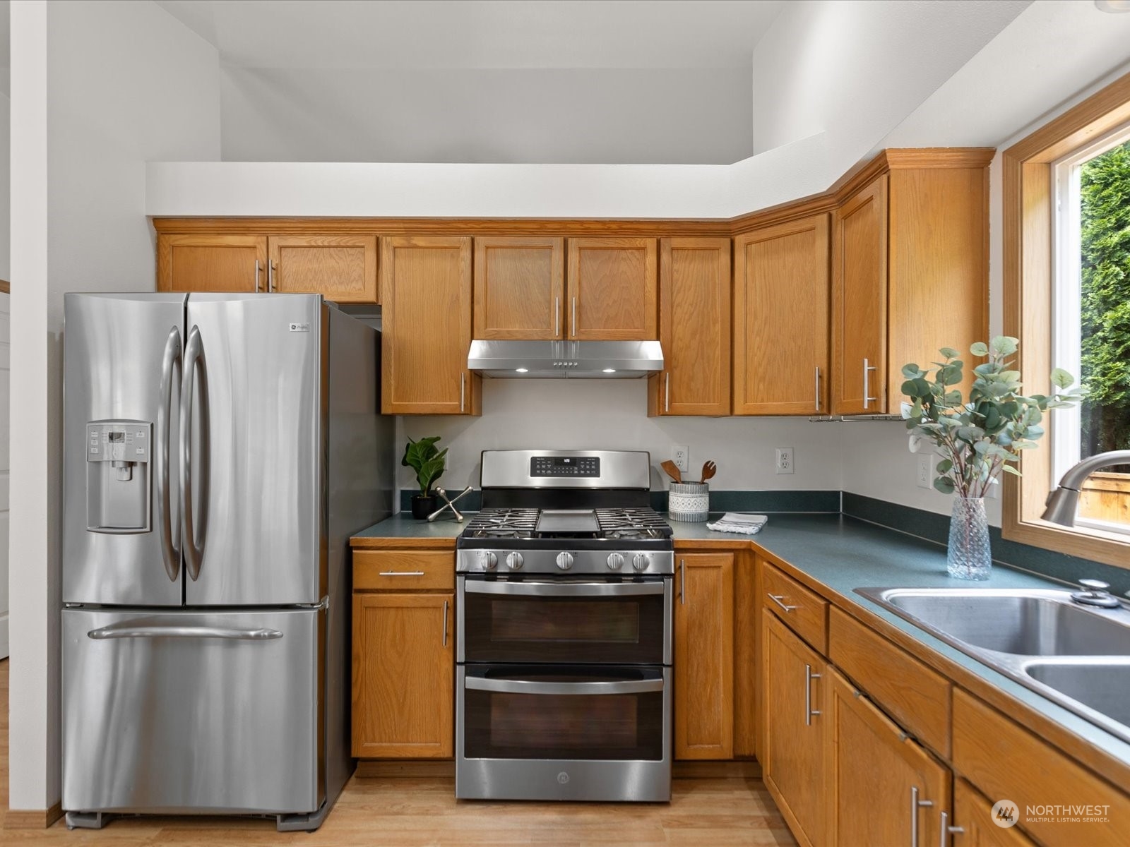 3415 189th Street Southeast Bothell, WA 98012 - Photo 10 of 33 a kitchen with a stove a refrigerator and a sink