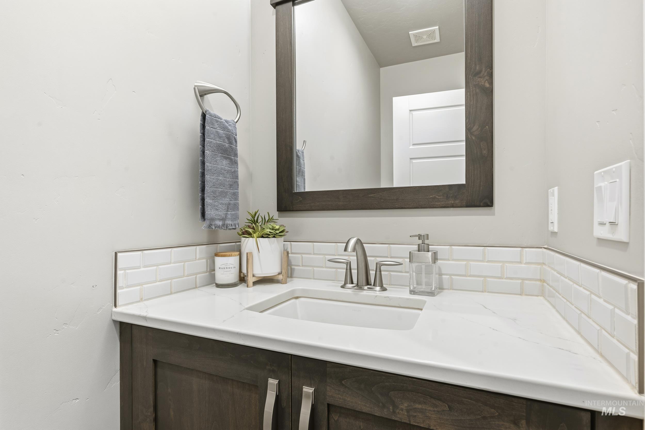 5699 North Fairborn Avenue Meridian, ID 83646 - Photo 15 of 30 Bathroom featuring vanity and backsplash