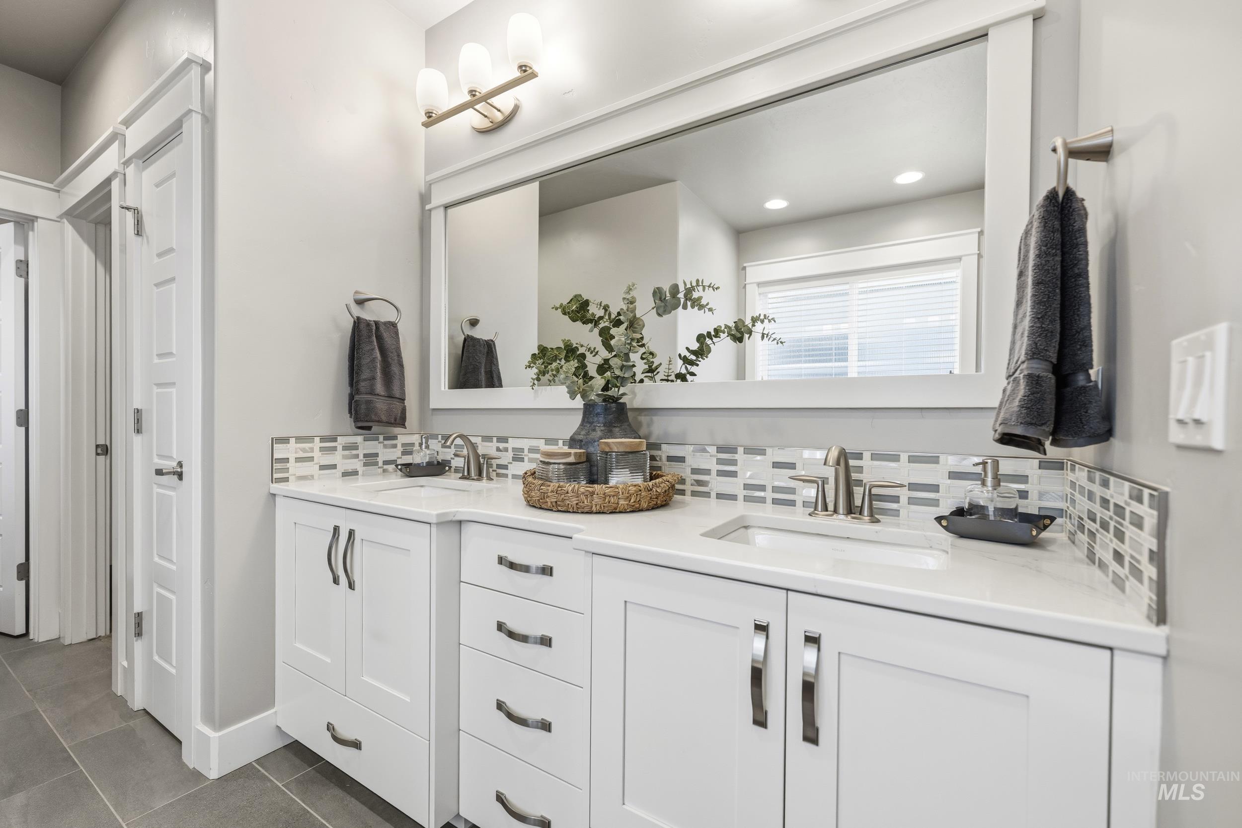 5699 North Fairborn Avenue Meridian, ID 83646 - Photo 19 of 30 Full bath featuring double vanity, backsplash, recessed lighting, and dark tile patterned flooring