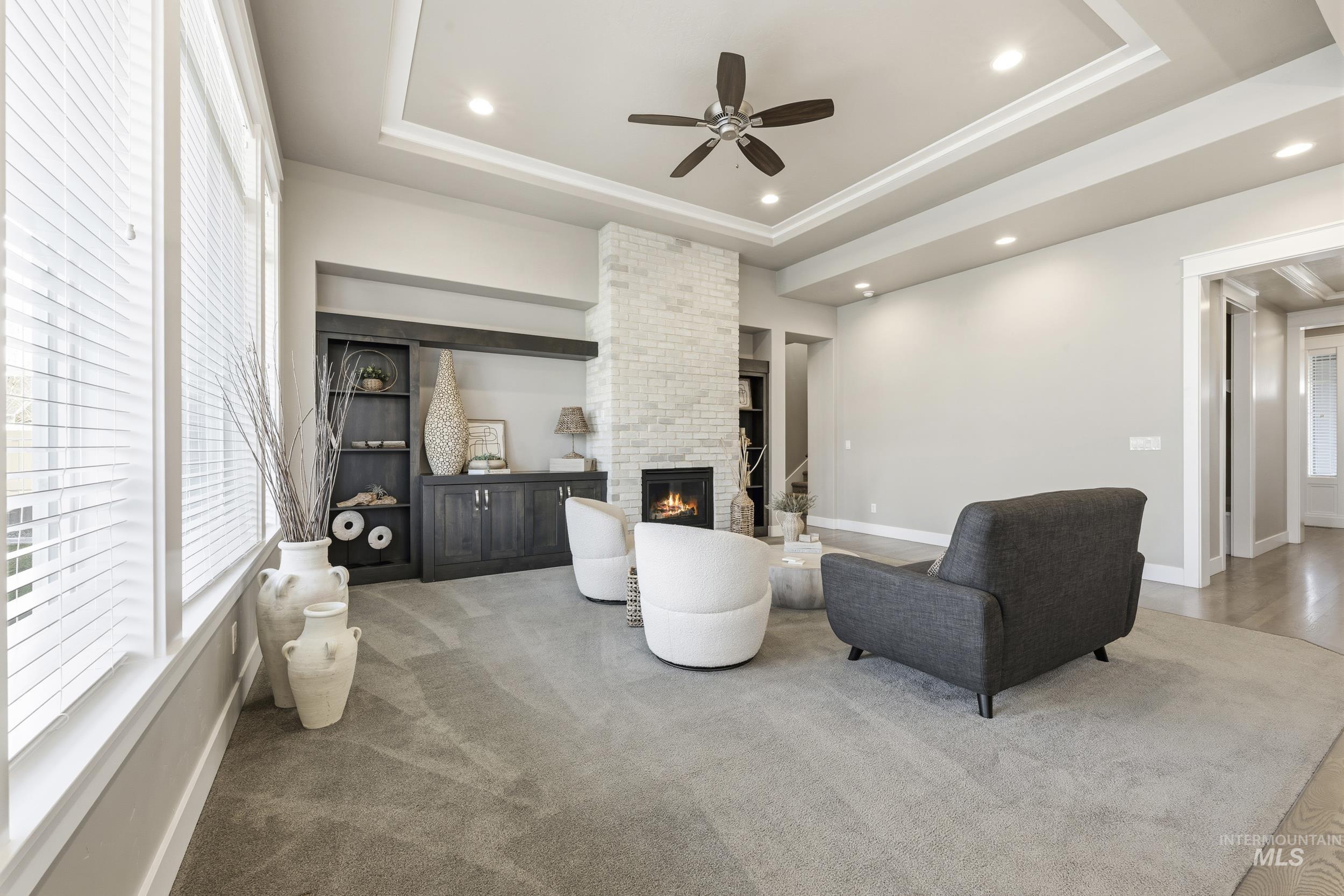 5699 North Fairborn Avenue Meridian, ID 83646 - Photo 4 of 30 Living area with a fireplace, recessed lighting, ceiling fan, and a raised ceiling