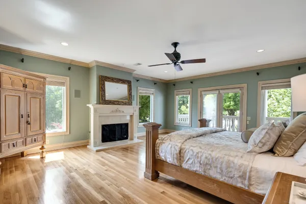a living room with furniture fireplace and a large window