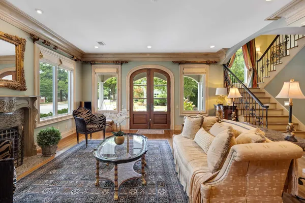 a kitchen with stainless steel appliances granite countertop a stove a refrigerator a sink a dining table and chairs