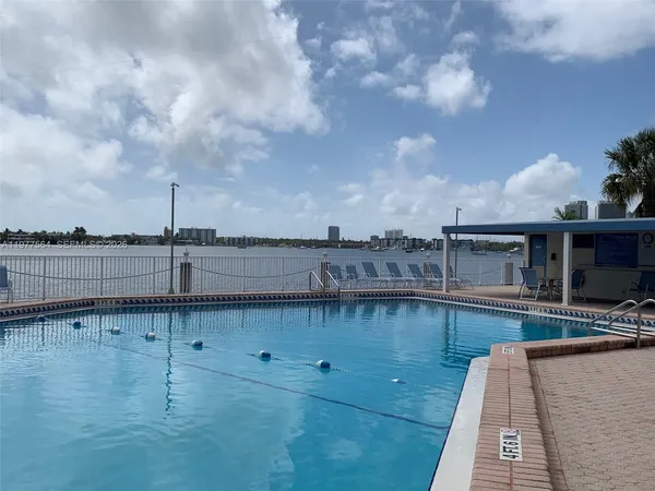 a view of a swimming pool with outdoor seating and plants