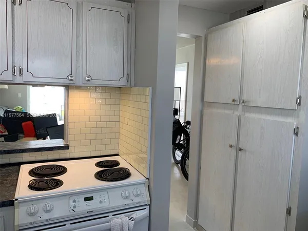 a kitchen with a stove and cabinets