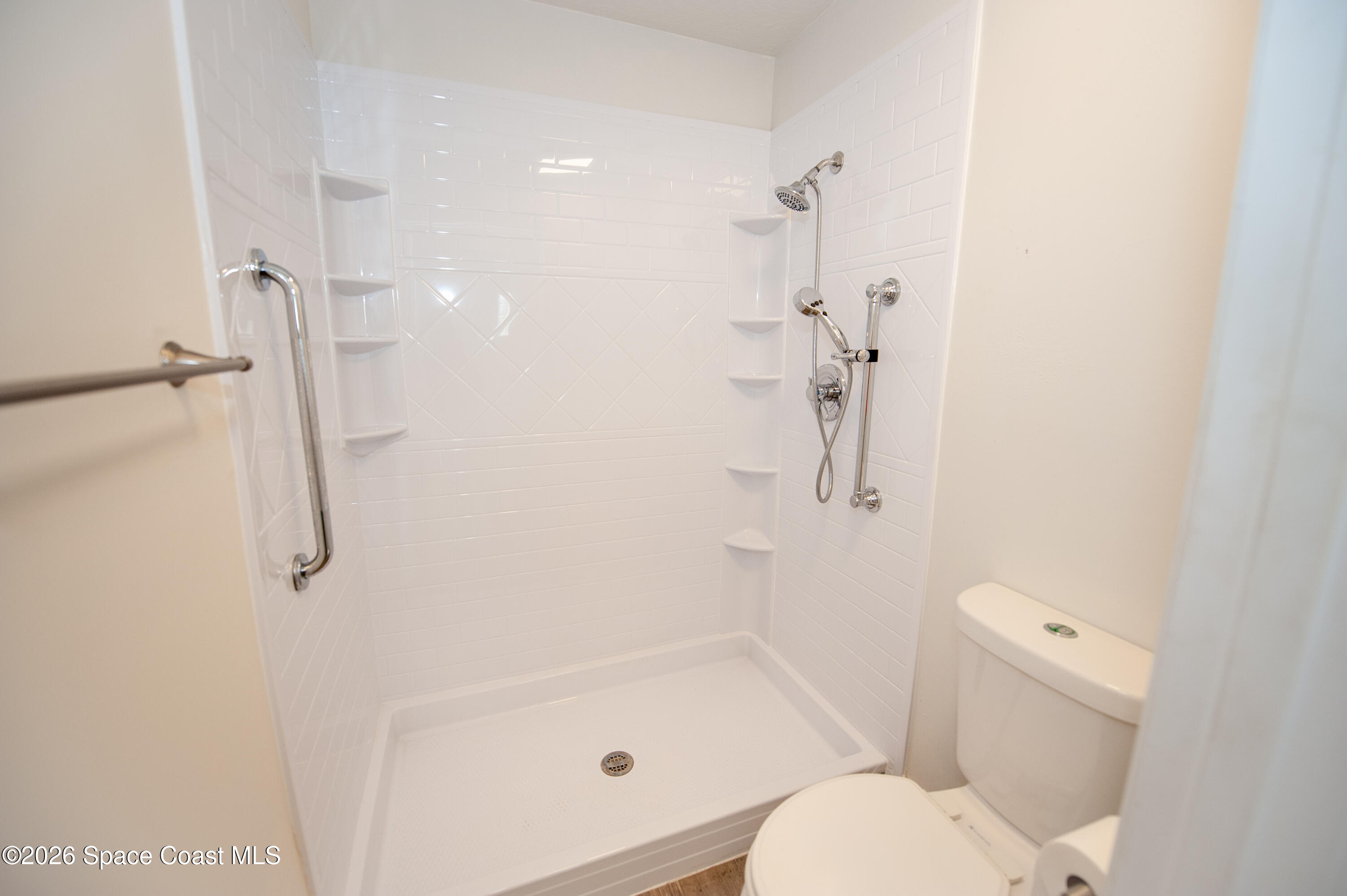 1942 Quail Ridge Court, Unit 504 Cocoa, FL 32926 - Photo 11 of 27 a bathroom with a shower and toilet