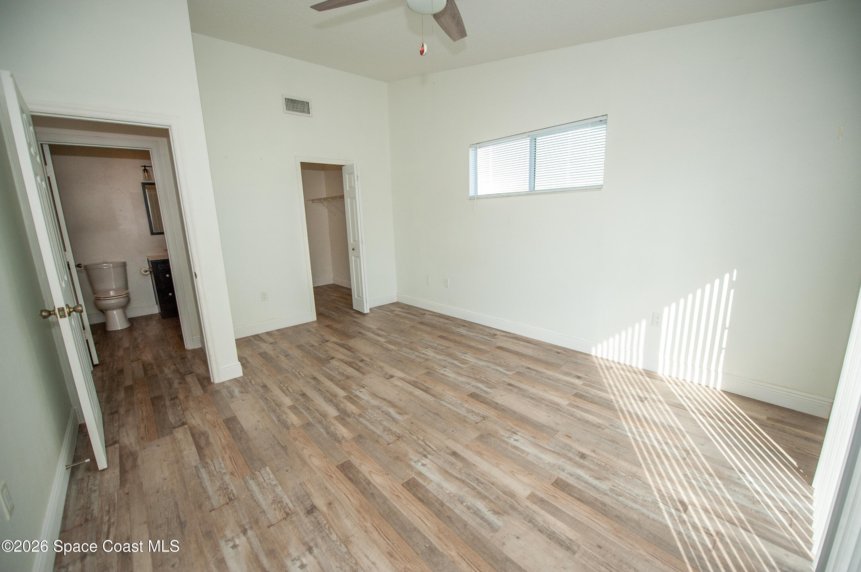 1942 Quail Ridge Court, Unit 504 Cocoa, FL 32926 - Photo 12 of 27 a view of a room with wooden floor and stairs