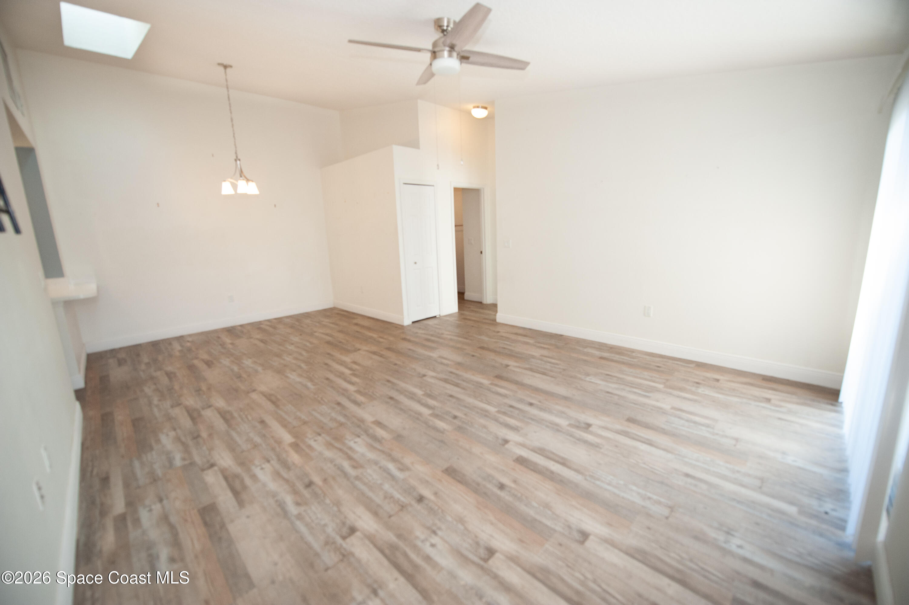 1942 Quail Ridge Court, Unit 504 Cocoa, FL 32926 - Photo 27 of 27 a view of a room with wooden floor and ceiling fan
