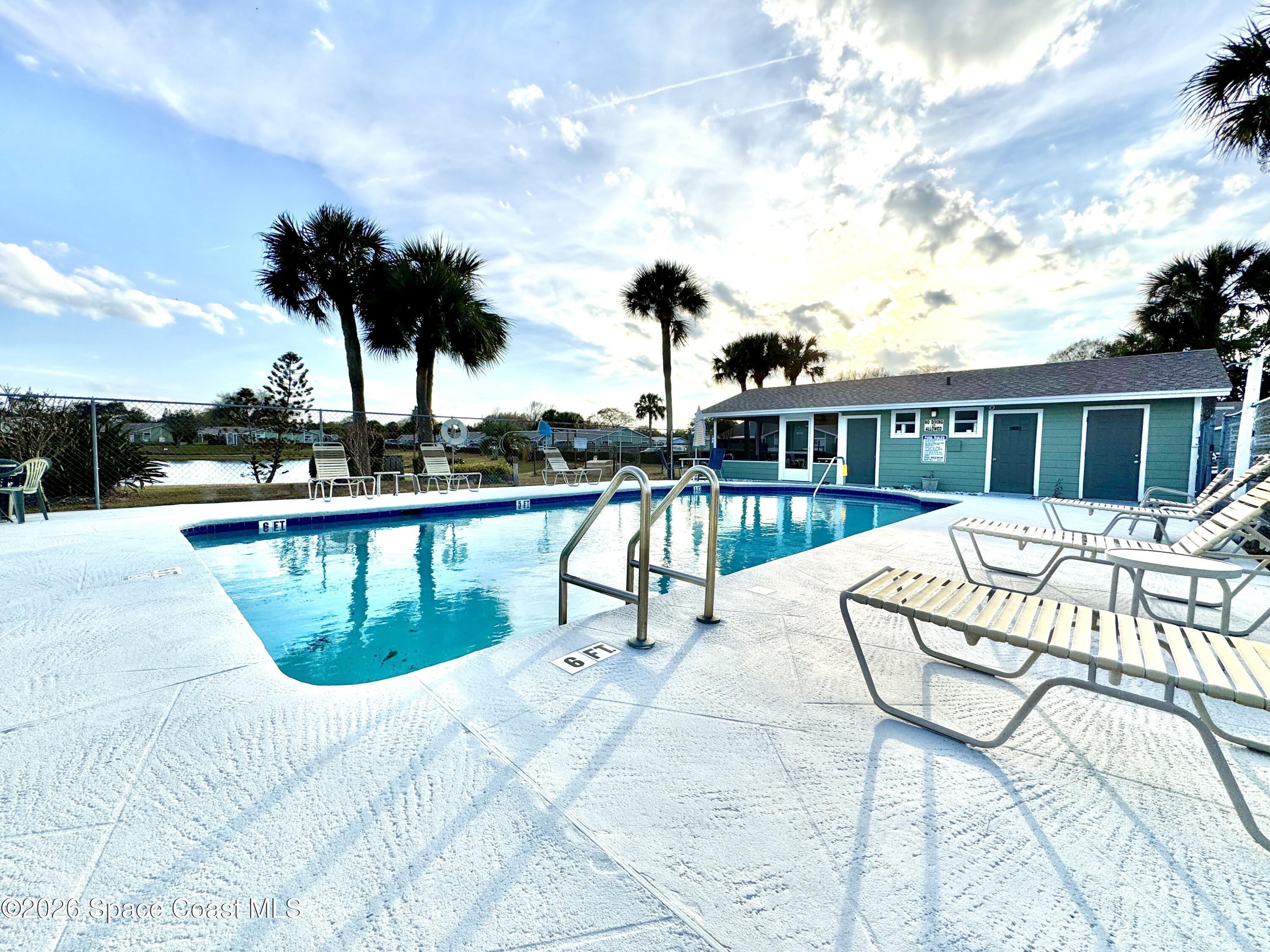 1942 Quail Ridge Court, Unit 504 Cocoa, FL 32926 - Photo 23 of 27 a view of swimming pool with outdoor seating